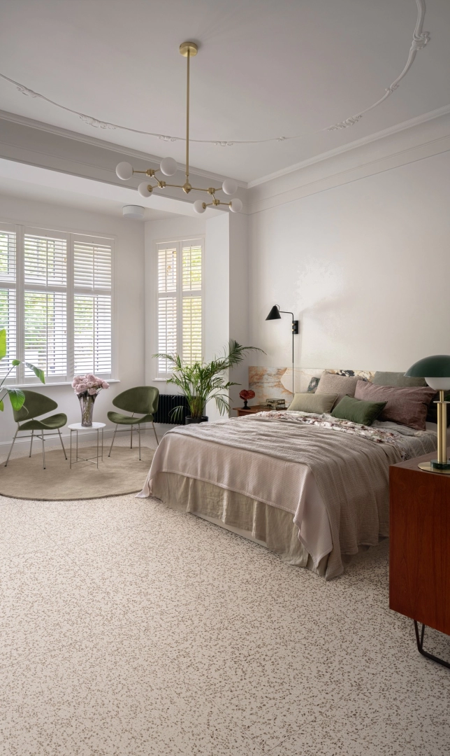 Wielkoformatowy gres Marazzi Frammento efekt terrazzo w salonie z kominkiem